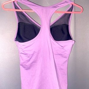 A purple sports tank with a built in bra from VSX Sports. Size Small (2-4).